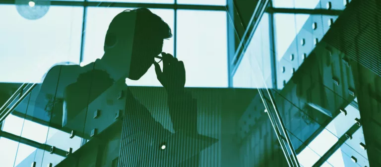 Outline of businessman reading tablet in an office.